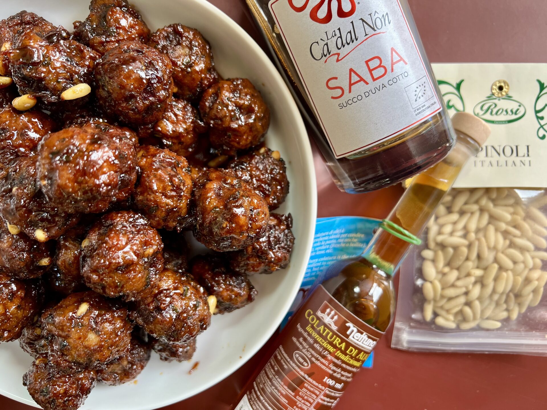 meatballs with saba, colatura, and pine nuts