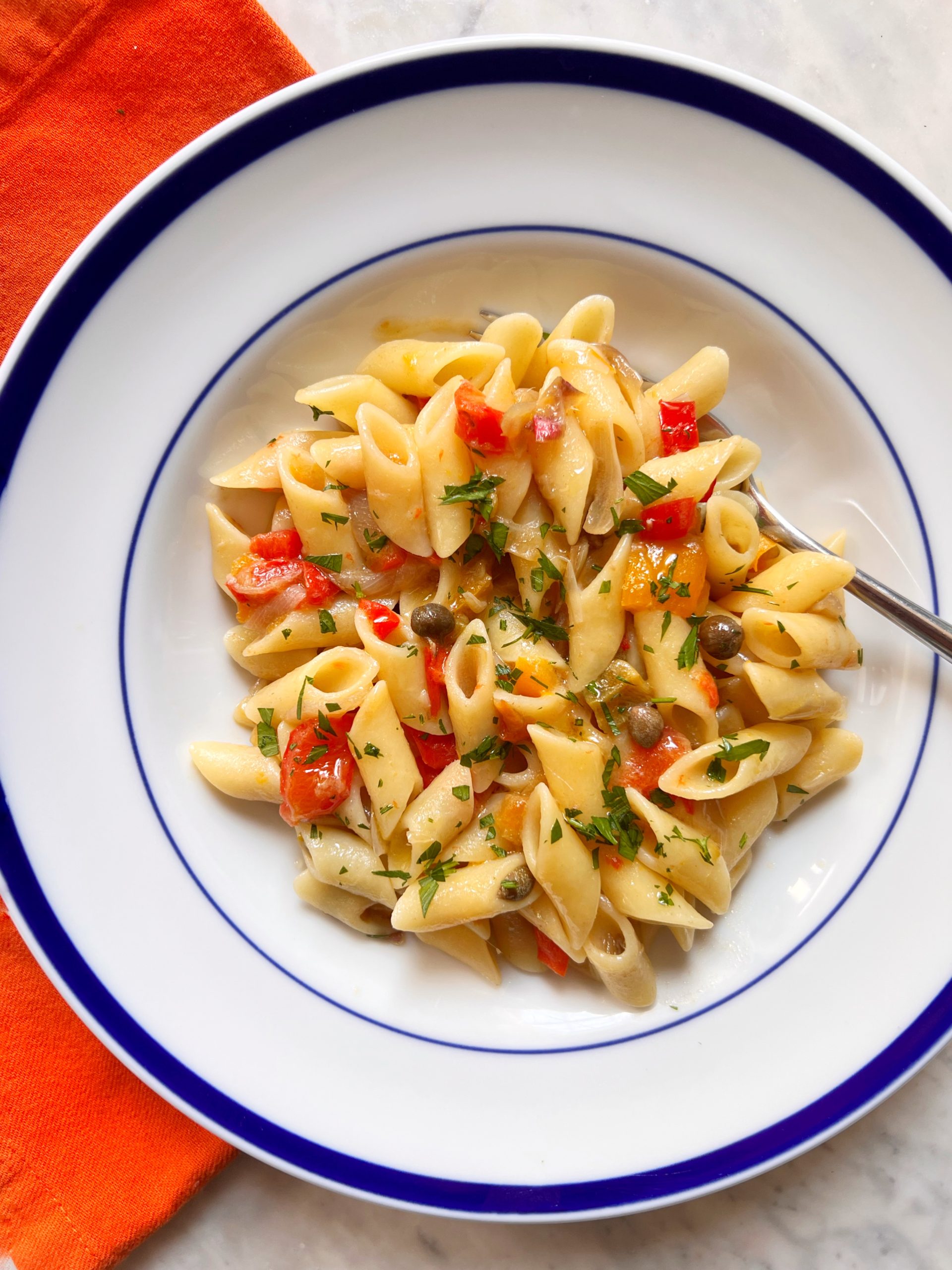 pasta on a plate with red peppers
